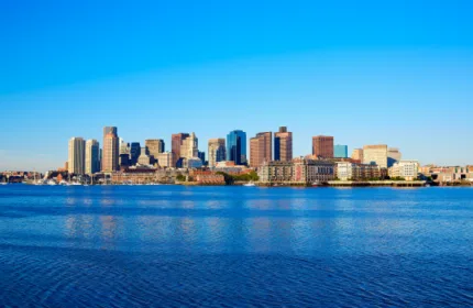 Boston skyline along the waterfront representing Massachusetts business landscape and Beacon Hill’s staffing industry recognition