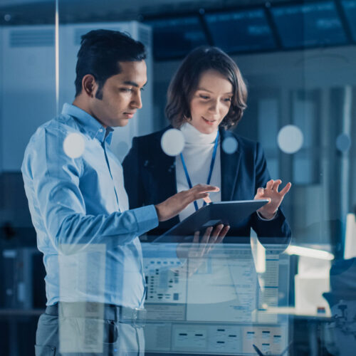 IT professionals reviewing data on a tablet for managed services and SOW planning