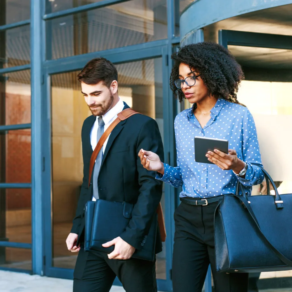 This image features a recruiter walking alongside a job seeker outside an office building, engaged in conversation. It visually represents the supportive guidance recruiters provide throughout the hiring journey, helping candidates navigate their career paths with confidence and clarity.