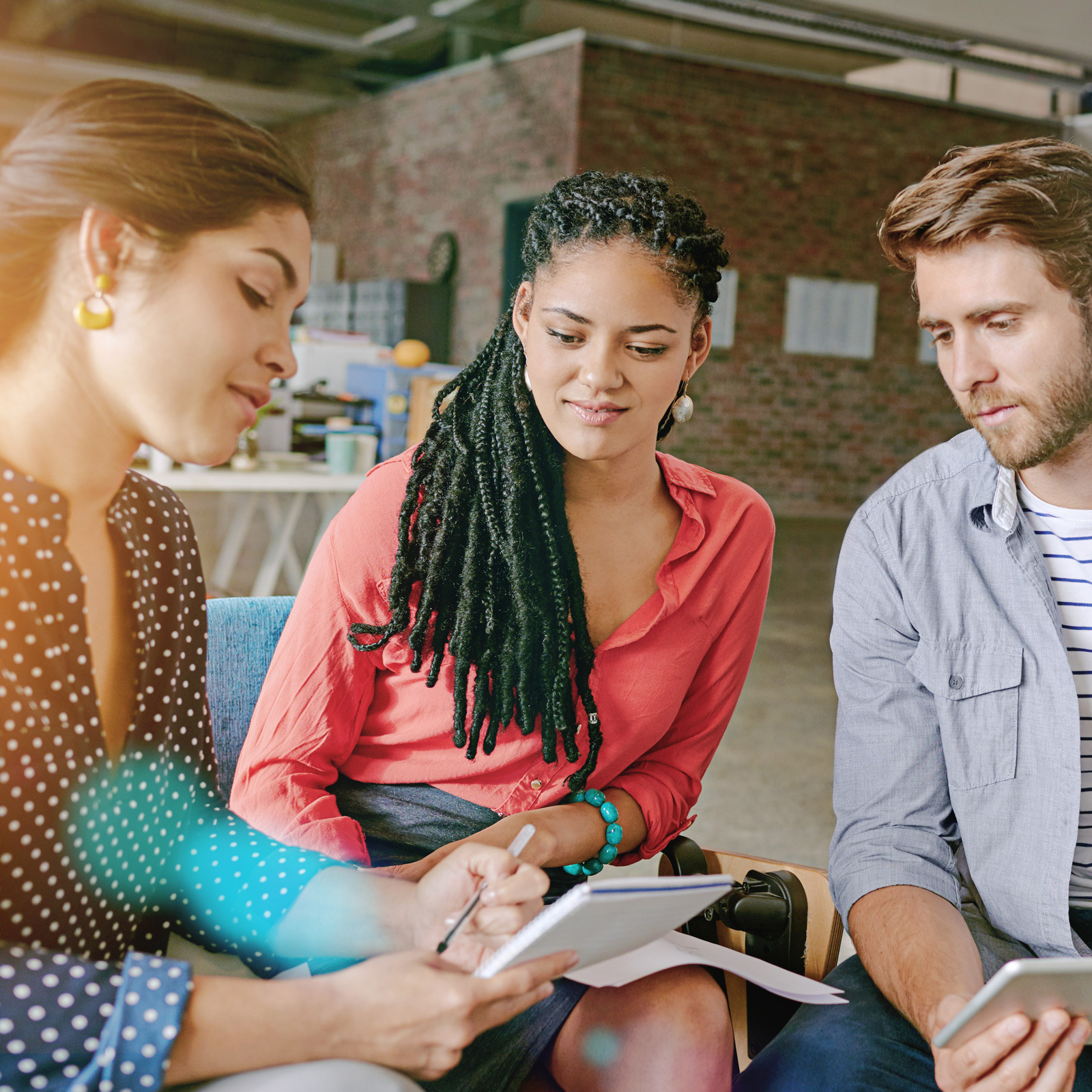 Three professionals collaborating in a modern office setting, representing Beacon Hill, a leading staffing and consulting firm known for connecting talent with opportunity across industries.