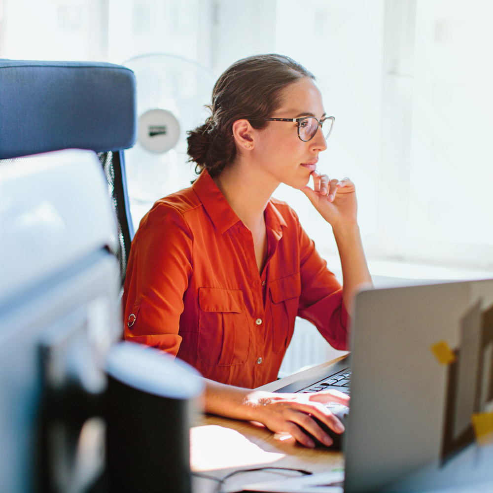 A dedicated IT consultant focuses intently while working on a laptop in a modern, light-filled office. This image represents the caliber of tech professionals available through our expert technology consulting and staffing services. From contract IT specialists to permanent tech talent, we deliver skilled consultants who drive innovation, efficiency, and transformation across industries. 4o